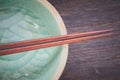 Wood brown chopsticks and celadon green ceramic Royalty Free Stock Photo