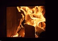 Wood burning in the furnace. Tongue of flame Royalty Free Stock Photo