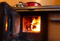 wood burning inside the stove to heat the house or the dishes and pots on the fire Royalty Free Stock Photo