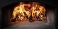 Wood burning inside a wood-burning oven for the preparation of classic Italian pizza Royalty Free Stock Photo