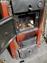 Wood burning inside the Solid bio fuel boiler. Renewable source of energy. green environmentally friendly fuel. Old warm Royalty Free Stock Photo