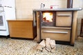 Wood-burning stove in the kitchen of a home with a moka pot Royalty Free Stock Photo