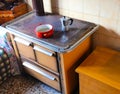 wood-burning stove in the kitchen of a house with a pot and a moka pot for making coffee Royalty Free Stock Photo