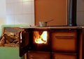 Wood burning stove in a kitchen of a mountain home with a pot on