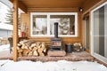 wood cabin porch with stacked firewood and snow Royalty Free Stock Photo