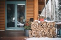 wood cabin porch with stacked firewood and snow Royalty Free Stock Photo