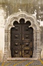 Wood carved door with stone work, lateral entrance of Elvas main church Royalty Free Stock Photo