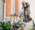 Wood carved statue of Saint Elizabeth with beggar in a charity g Royalty Free Stock Photo