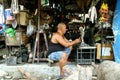 Wood carver puts finishing touches on an ornamental figurine sold at Dapitan Arcade in Manila, Philippines