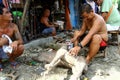 Wood carver puts finishing touches on an ornamental figurine sold at Dapitan Arcade in Manila, Philippines