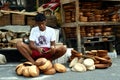 Wood carver puts finishing touches on wooden plates sold at Dapitan Arcade in Manila, Philippines