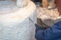 Wood carver working on a large sculpture of Winnie the Pooh Royalty Free Stock Photo