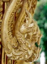 Wood carving is a golden serpent in Thai temple