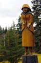 Wood carving of Qualicum Bay First Nations woman overlooking the sea