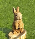 Wood carving of a rabbit in a garden woodworking