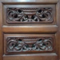This is a wood carving on the surface of a drawer in a cupboard Royalty Free Stock Photo