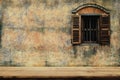 Wood chair with old cement wall and a wooden window background Royalty Free Stock Photo