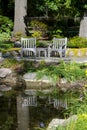 Wood chairs by a pond Royalty Free Stock Photo