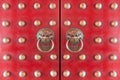 Wood Chinese door painted with red color with traditional bronze chinese lion head knockers.wood door entrance of chinese temple Royalty Free Stock Photo