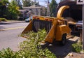 Wood chipper while chopping branches. Cleaning works in the suburbs