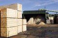 Wood chips pellets chopped wooden logs and stacked wooden pallets for biomass fuel at sawmill Royalty Free Stock Photo