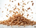 Wood chips pile with more pieces falling down in motion against white backdrop. Natural organic material creates textured pattern Royalty Free Stock Photo