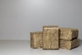 Wood chips, sawdust un flax pressed briquettes for heating. Solid fuel, briquettes, can be used as firewood, on a gray background Royalty Free Stock Photo