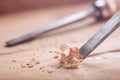 Wood chisel cutting out groove in old pine plank for the door lock