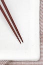 Wood chopsticks and white ceramic plate Royalty Free Stock Photo