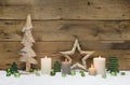 Wood Christmas decoration with green balls, candles and stars on