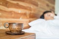 Wood coffee cup on table and women on the bed Royalty Free Stock Photo