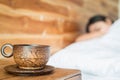 Wood coffee cup on table and women on the bed Royalty Free Stock Photo