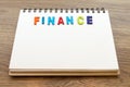 Wood colorful letter word finance lay down notebook on wood back