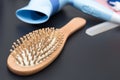 Wood comb with dropped hair. Royalty Free Stock Photo