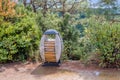 Wood and concrete trash can on hiking trail