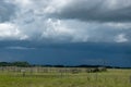 Wood Corral with approaching storm clouds, Saskatchewan, Canada. Royalty Free Stock Photo