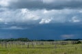 Wood Corral with approaching storm clouds, Saskatchewan, Canada. Royalty Free Stock Photo