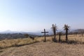 Wood Cross on Hilltop with Three Aloe Plants Depicting Crucifixion