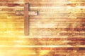 Wood cross on wooden background in church with ray of light Royalty Free Stock Photo