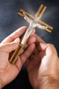 Wood Crucifix Held in Two Hands