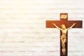 Wood crucifix on white brick wall background with the body of Ch