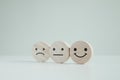 Wood cube with smile, normal and sad face. Negative, neutral and positive facial expressions. Royalty Free Stock Photo