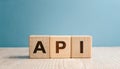 Wood cubes with abbreviation text API on wooden table. Application Programming Interface