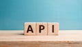 Wood cubes with abbreviation text API on wooden table. Application Programming Interface
