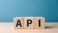 Wood cubes with abbreviation text API on wooden table. Application Programming Interface