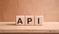 Wood cubes with abbreviation text API on wooden table. Application Programming Interface