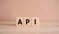 Wood cubes with abbreviation text API on wooden table. Application Programming Interface