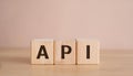 Wood cubes with abbreviation text API on wooden table. Application Programming Interface