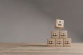 Wood cubes with new head of team or CEO on a beautiful wooden table, studio background. Business concept and copy space