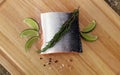 Wood cutting board in kitchen table with fresh red salmon fish salt pepper and lime ready to cook. Royalty Free Stock Photo